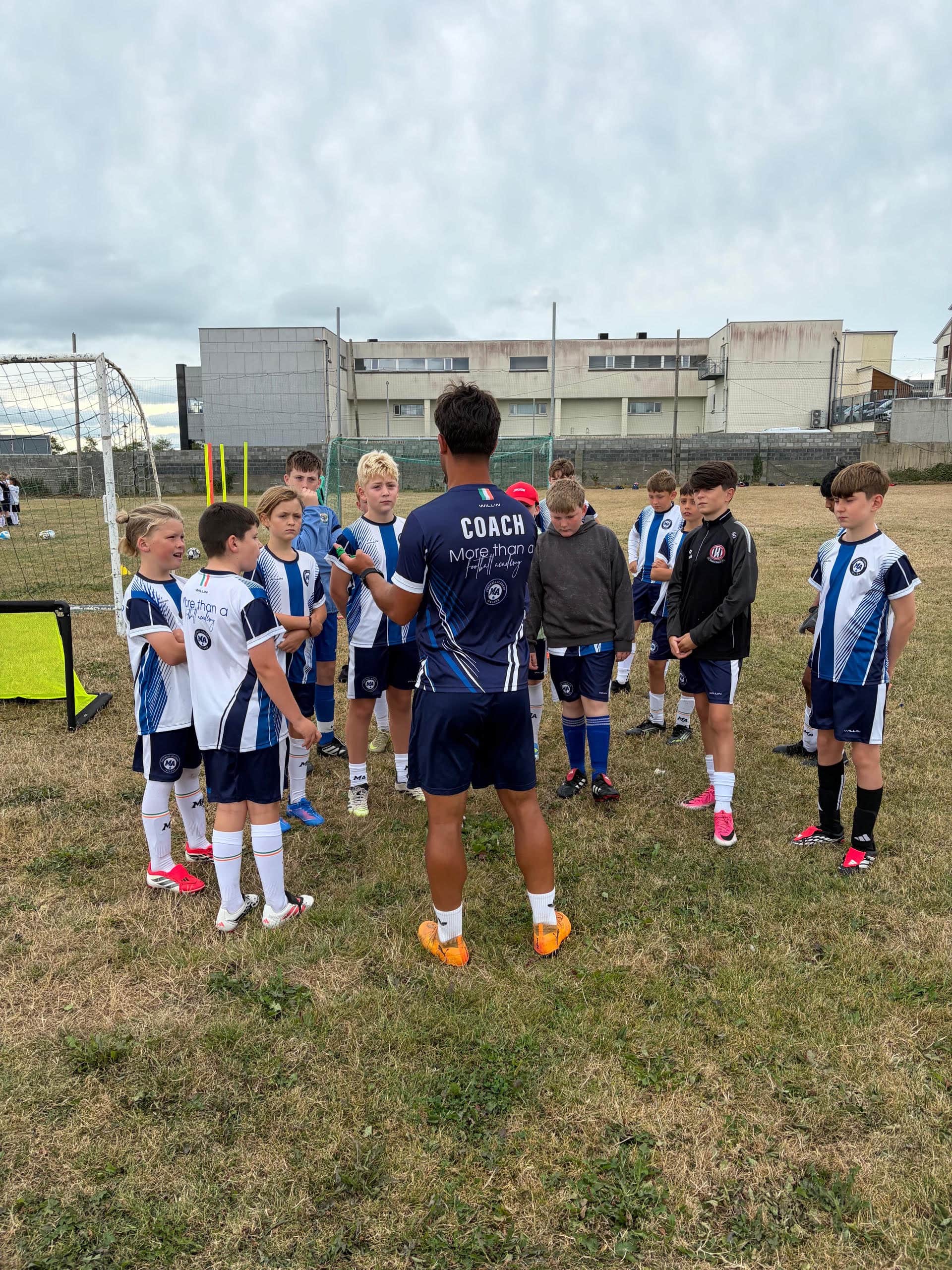 M&A Football Academy coach addressing the full squad