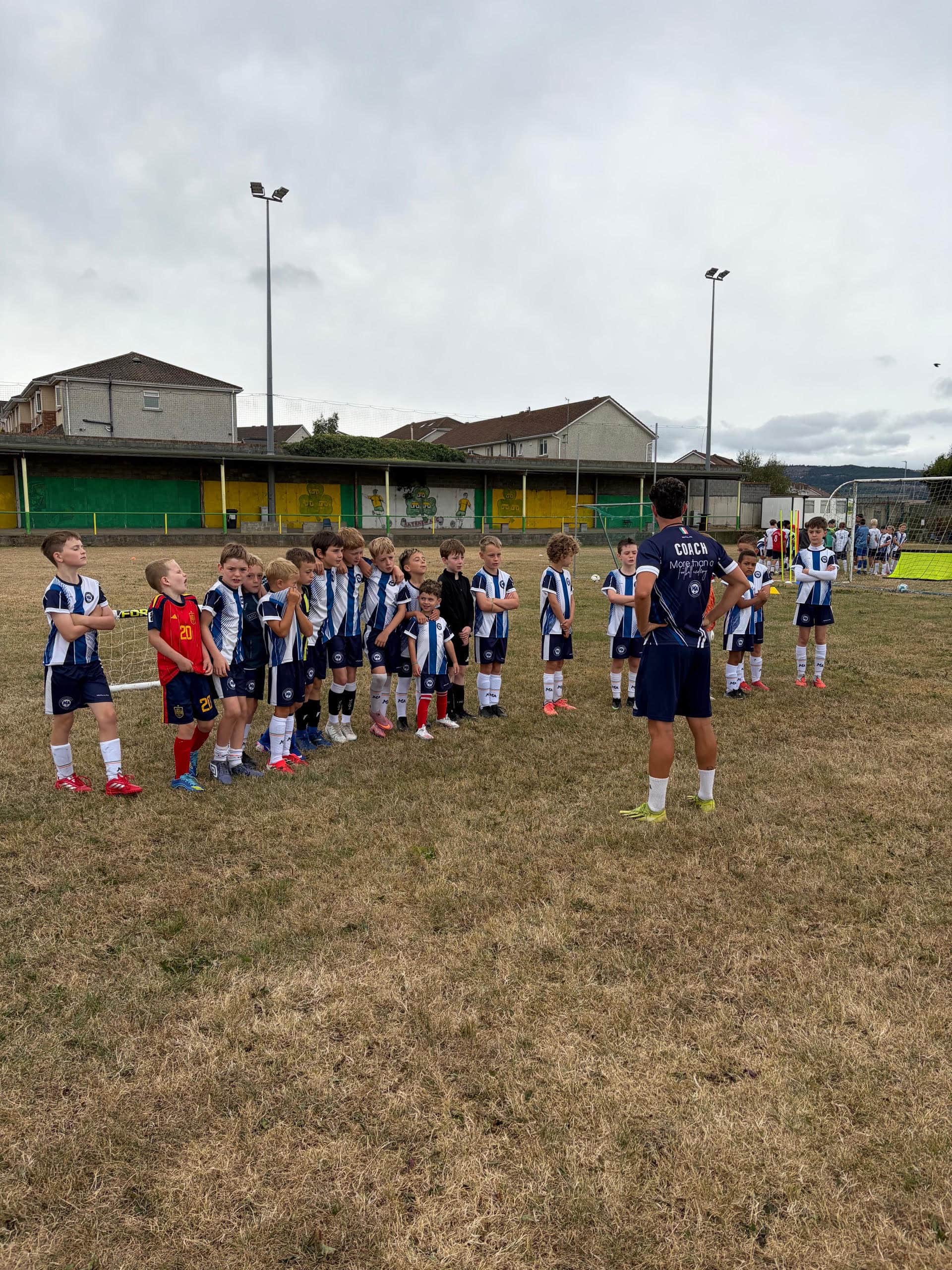 M&A Football Academy squad lined up with their coach